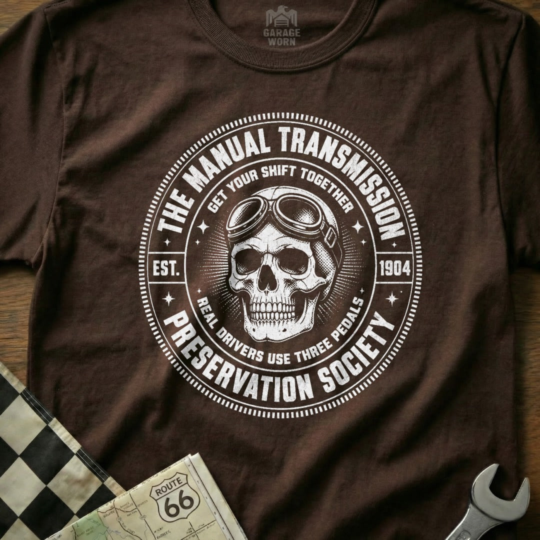 Brown t-shirt featuring a skull with goggles and the text "The Manual Transmission Preservation Society".