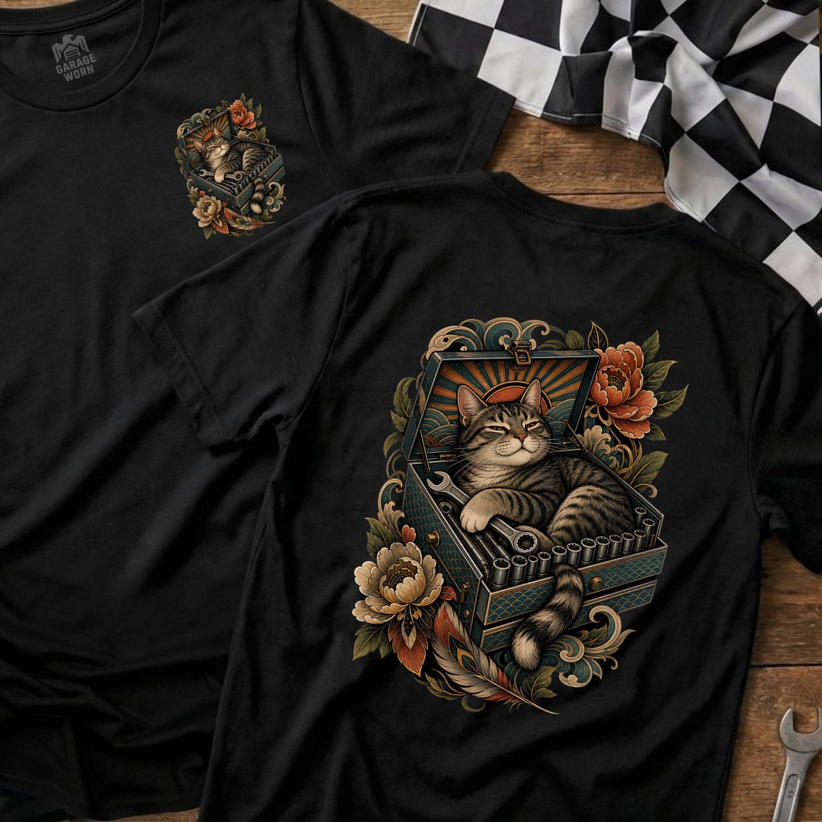 Black t-shirt featuring a tabby cat resting in a toolbox with tools and floral accents.