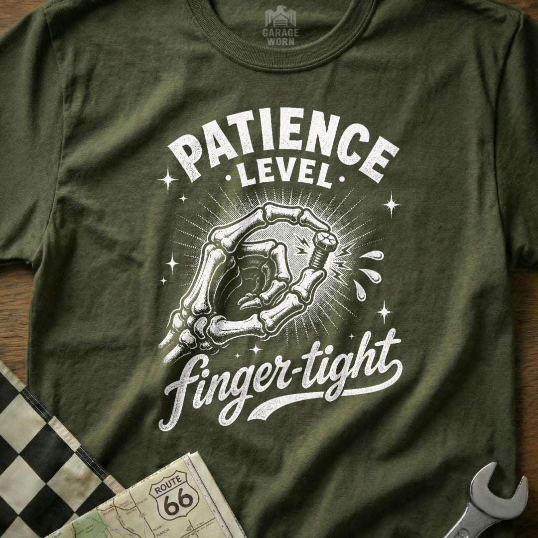 Olive green t-shirt with white text "PATIENCE LEVEL finger-tight" and skeleton hand holding bolt.