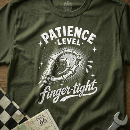 Olive green t-shirt with white text "PATIENCE LEVEL finger-tight" and skeleton hand holding bolt.