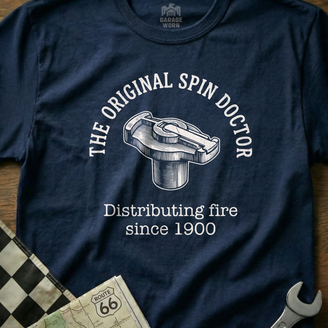 Navy t-shirt with "The Original Spin Doctor Distributing fire since 1900" and a car distributor cap graphic.