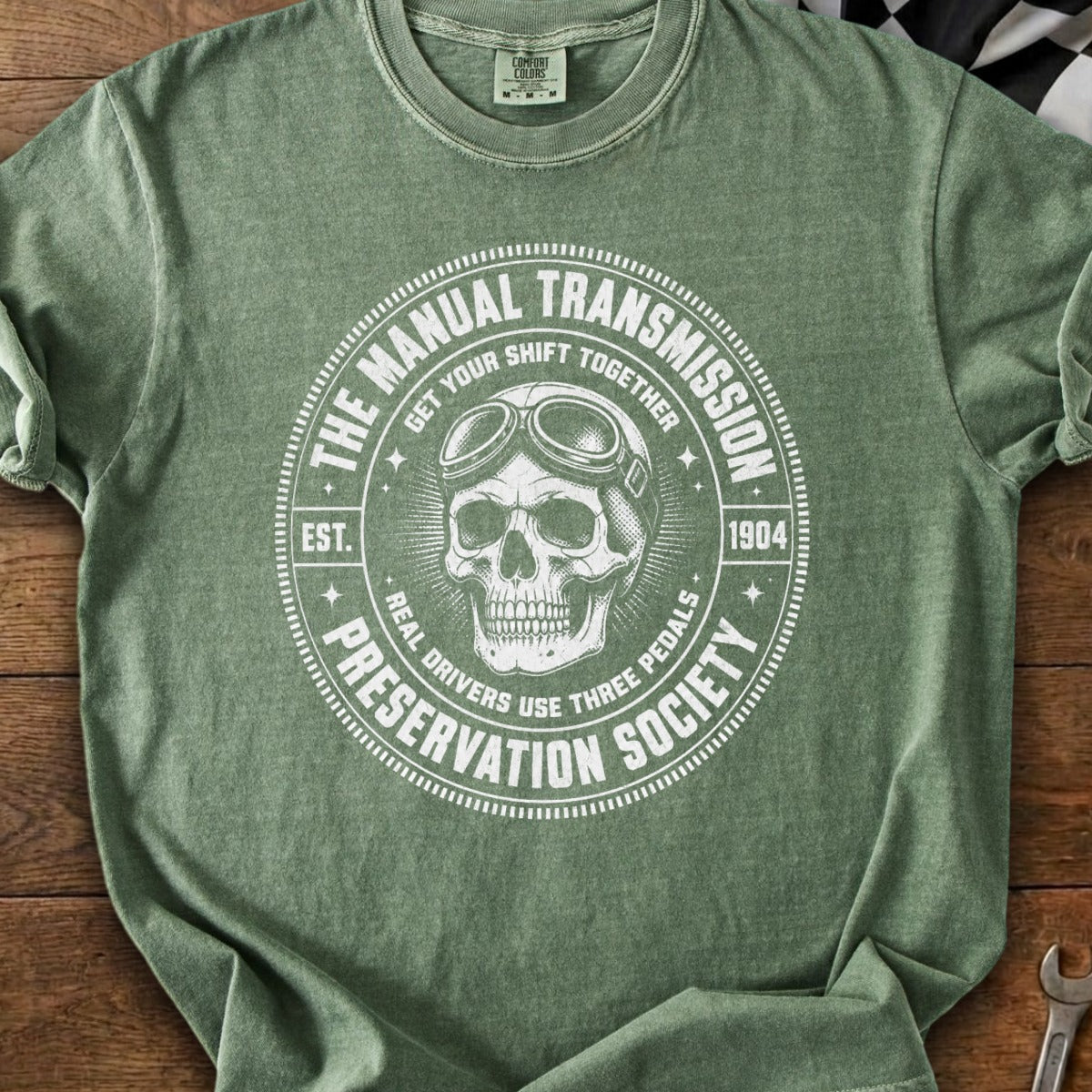Graphic tee with a skull wearing aviator goggles and text about manual transmissions.