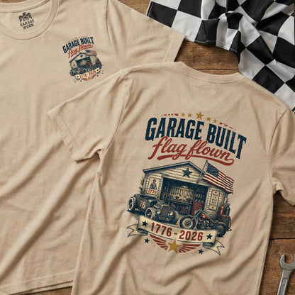 Tan t-shirt with "Garage Built Flag Flown 1776-2026" graphic and hot rod.