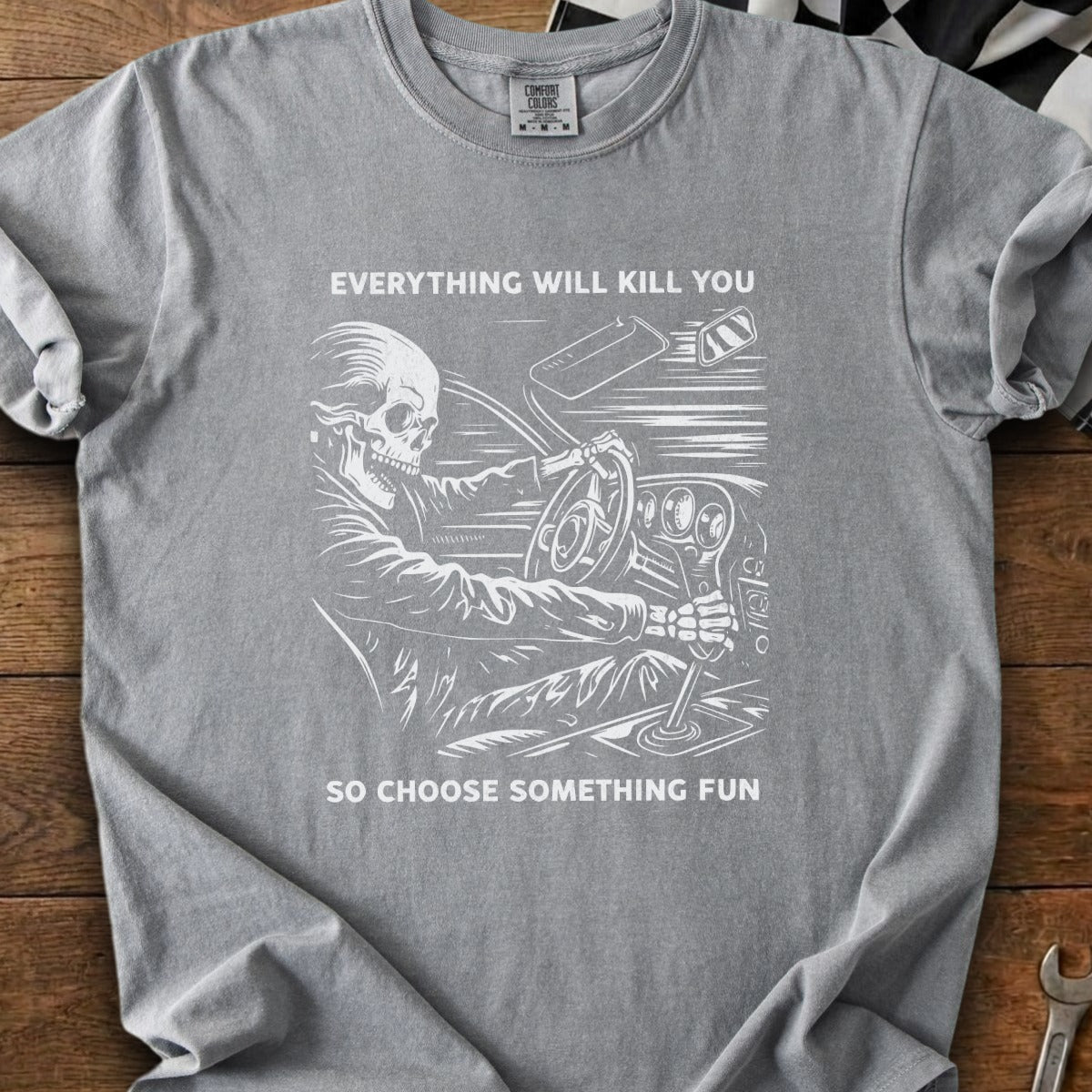 Gray t-shirt with skeleton driving and text "EVERYTHING WILL KILL YOU SO CHOOSE SOMETHING FUN".