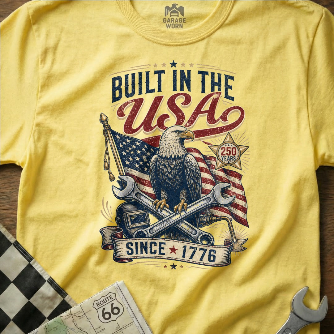 Yellow t-shirt with "Built in the USA" design, eagle, flag, and tools.