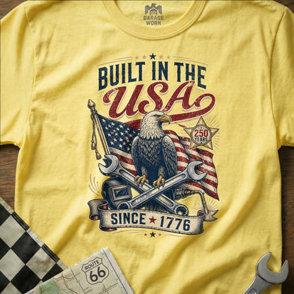 Yellow t-shirt with "Built in the USA" design, eagle, flag, and tools.