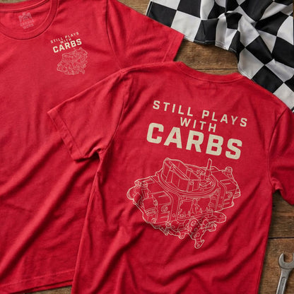 Red t-shirt with white text "STILL PLAYS WITH CARBS" and carburetor graphic.