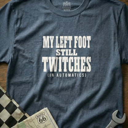 Navy t-shirt with white text "MY LEFT FOOT STILL TWITCHES (IN AUTOMATICS)".
