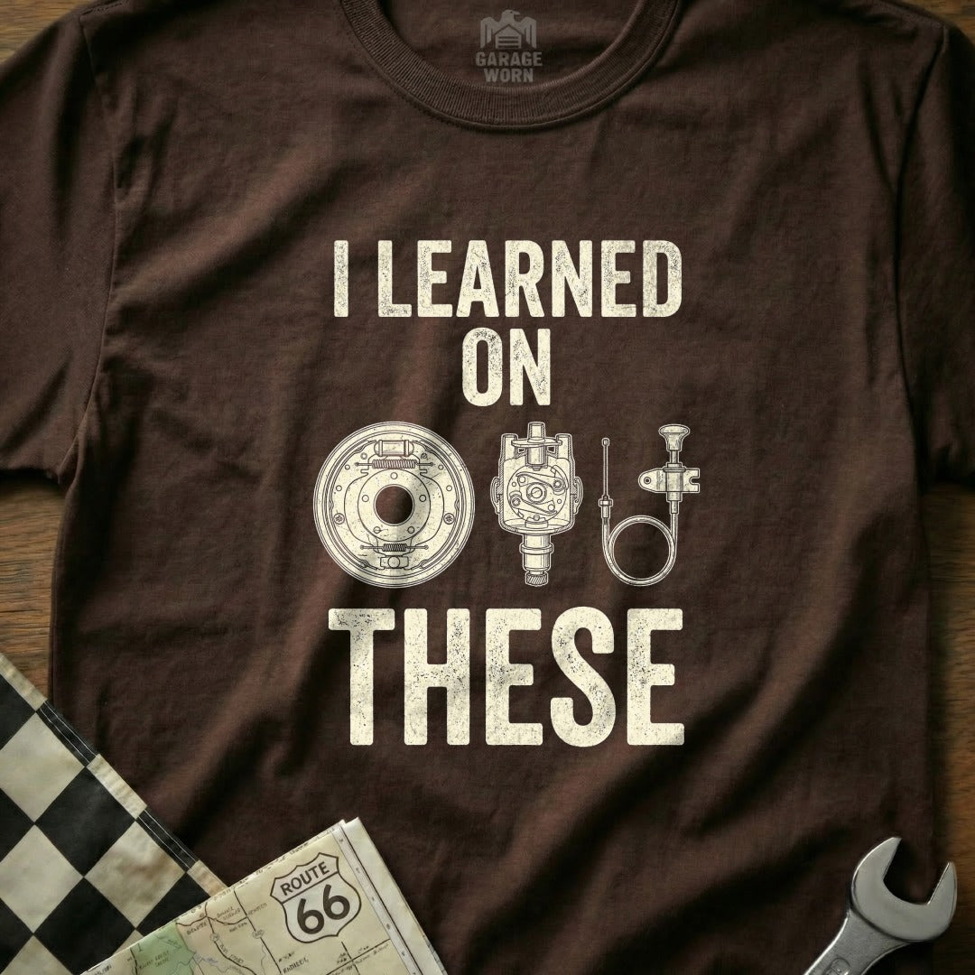 Brown t-shirt with "I learned on these" and illustration of auto parts.