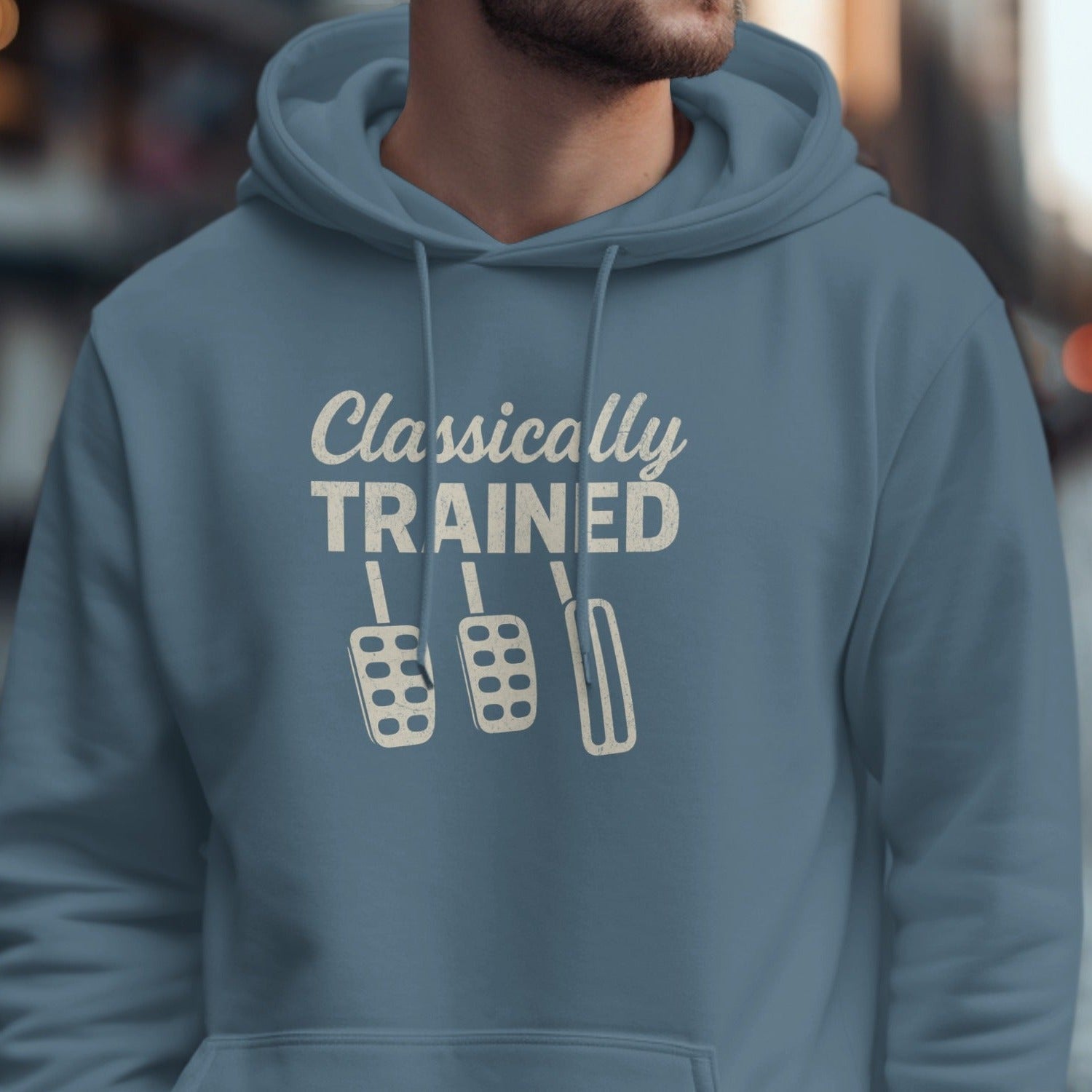 Blue hoodie with "Classically TRAINED" and three manual car pedals graphic.