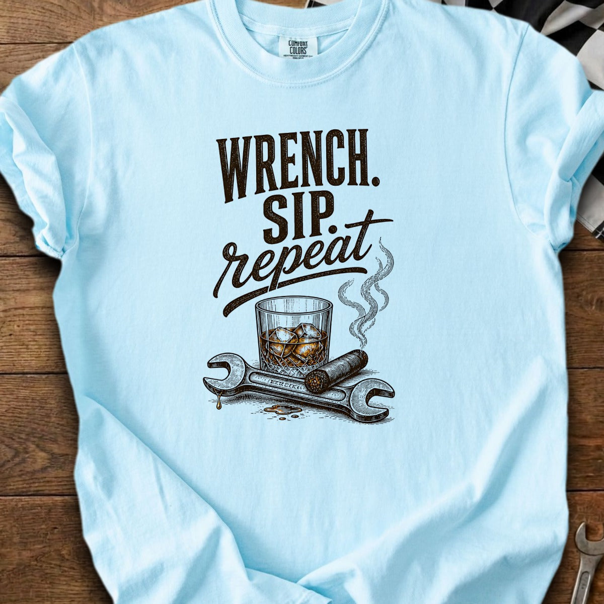 Light blue t-shirt with "Wrench. Sip. Repeat." text and graphic.