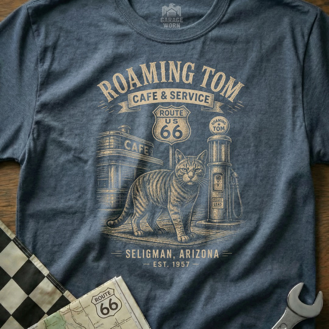 T-shirt graphic with cat, gas pump, Route 66 sign, and "Roaming Tom Cafe".