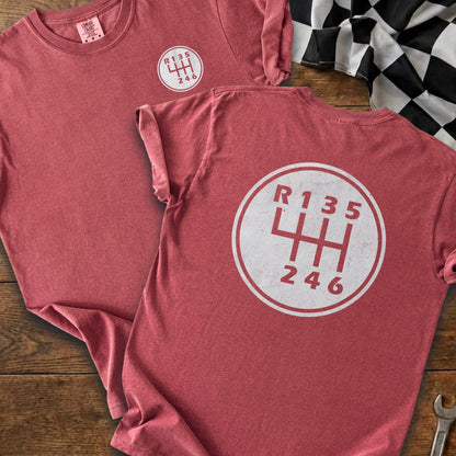 Crewneck t-shirt with a manual car transmission shift pattern graphic.
