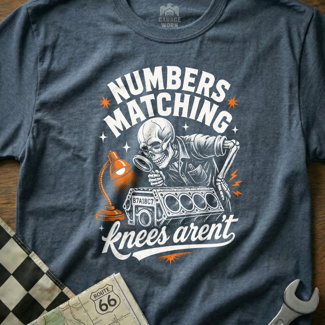 Skeleton mechanic examines engine block with magnifying glass, "Numbers matching knees aren't" text.