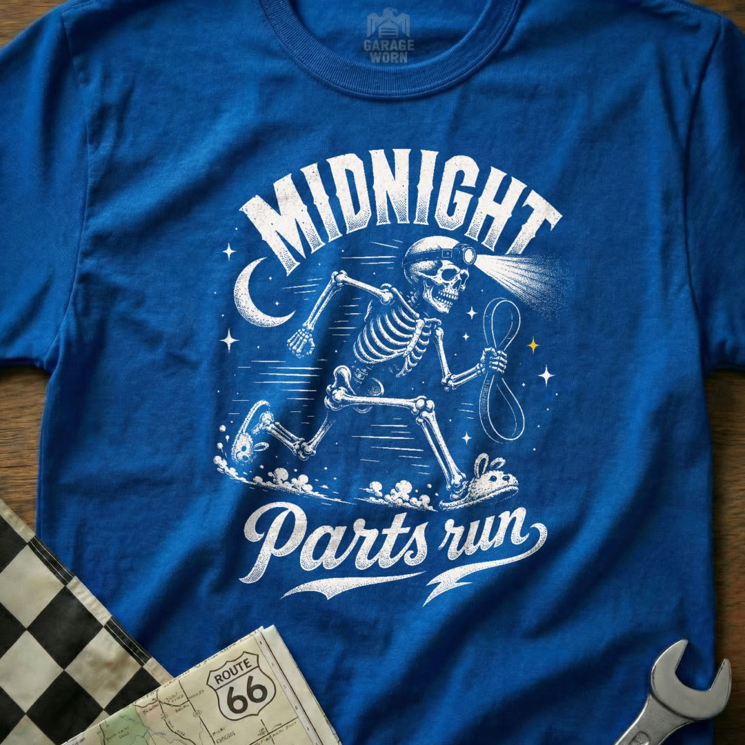 Blue t-shirt featuring a skeleton running with a headlamp and rope, text "Midnight Parts run".