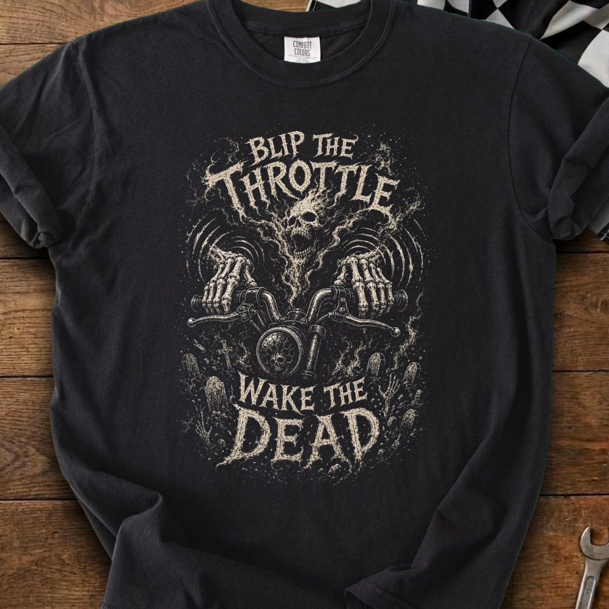 Black t-shirt with skeletal hands riding a motorcycle graphic and text "Blip the Throttle Wake the Dead".