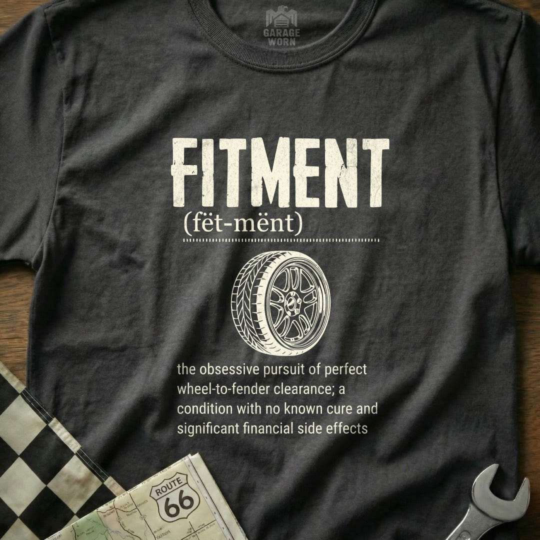 T-shirt with "FITMENT" and definition, featuring a tire and wheel graphic.