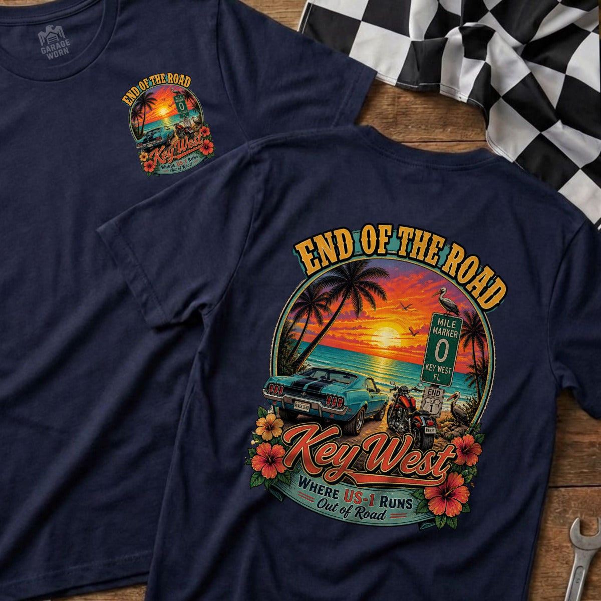 Navy t-shirt featuring "End of the Road Key West" graphic with car, motorcycle, and beach sunset.