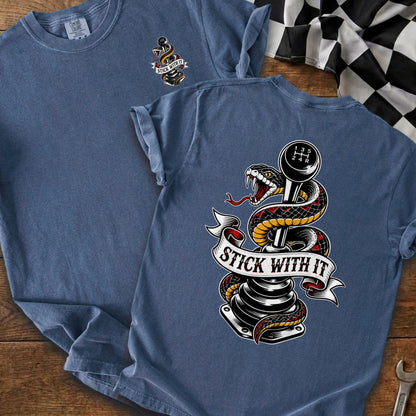 Blue t-shirt with a snake wrapped around a stick shift and "Stick With It" text.