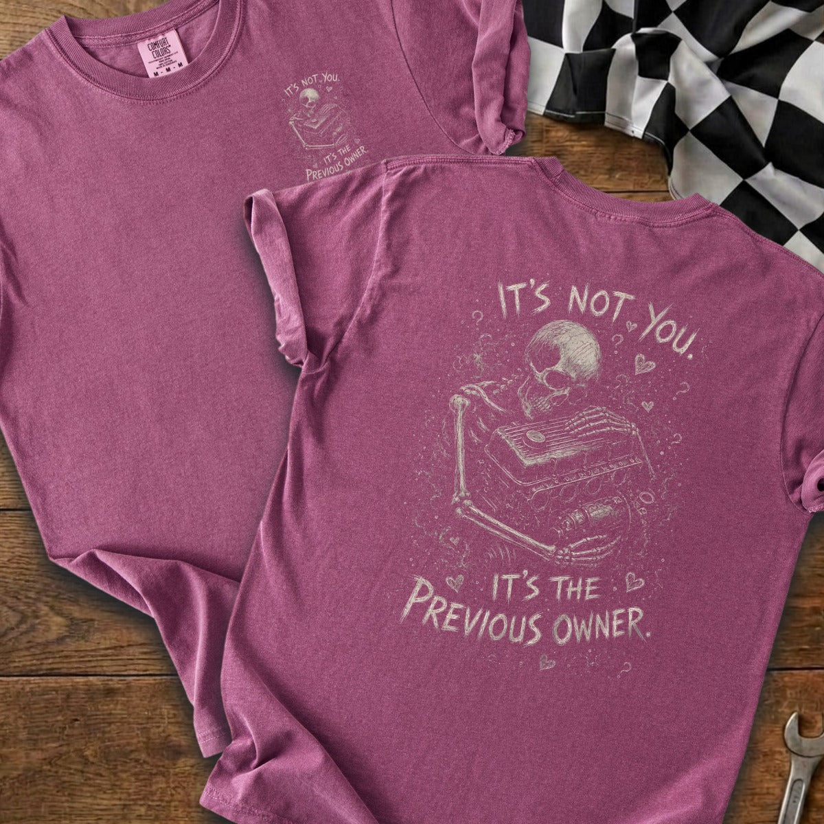 Maroon t-shirt with a skeleton holding an engine and text that says "It's not you. It's the previous owner."
