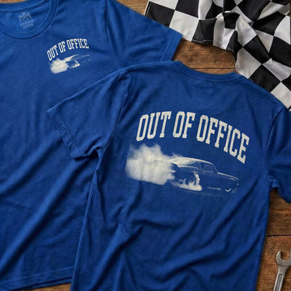 Blue t-shirt with "OUT OF OFFICE" text and a car burnout graphic.