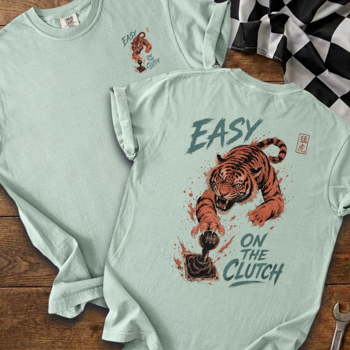 Mint green t-shirt with a tiger graphic and the text "EASY ON THE CLUTCH".