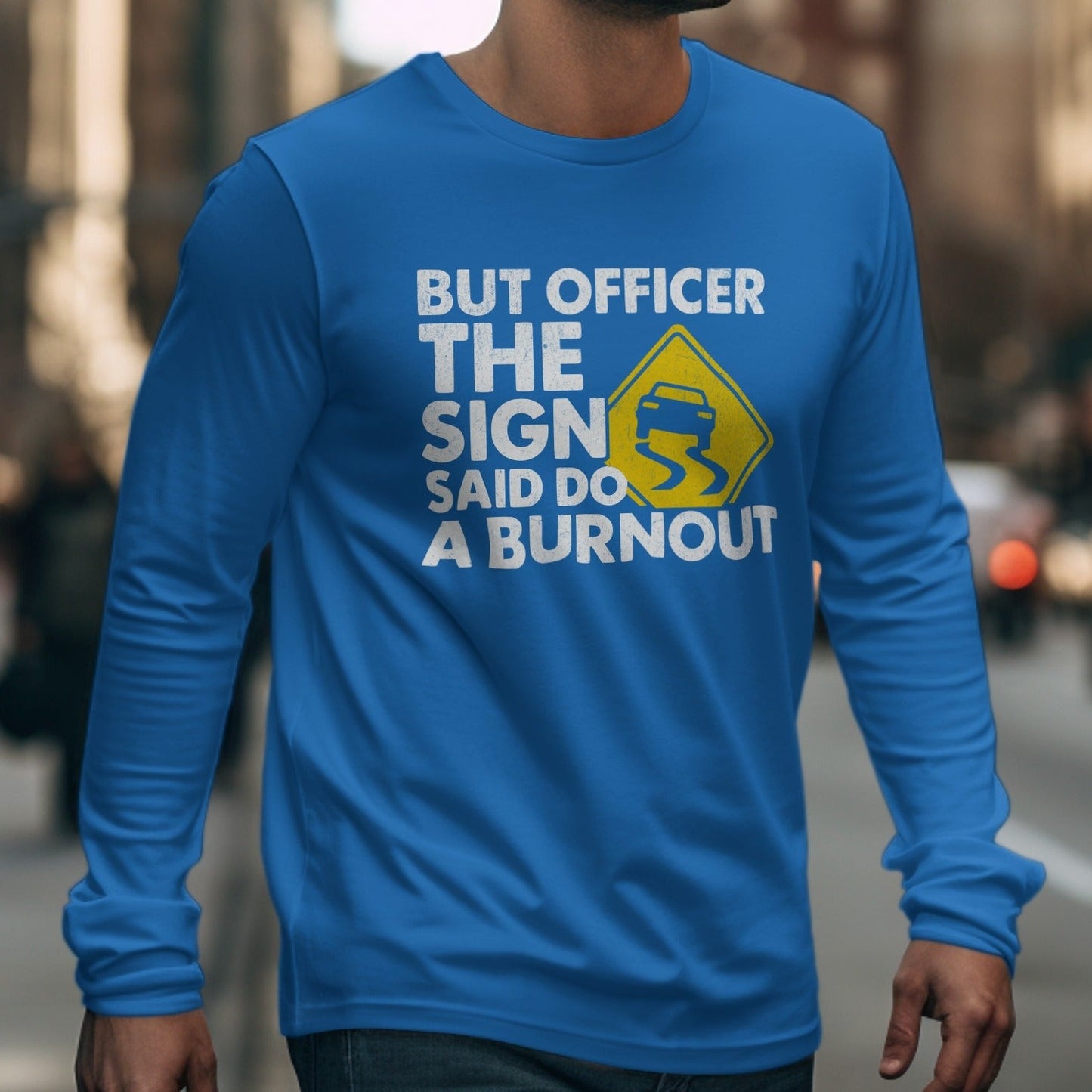 Blue long-sleeve shirt with text "BUT OFFICER THE SIGN SAID DO A BURNOUT".