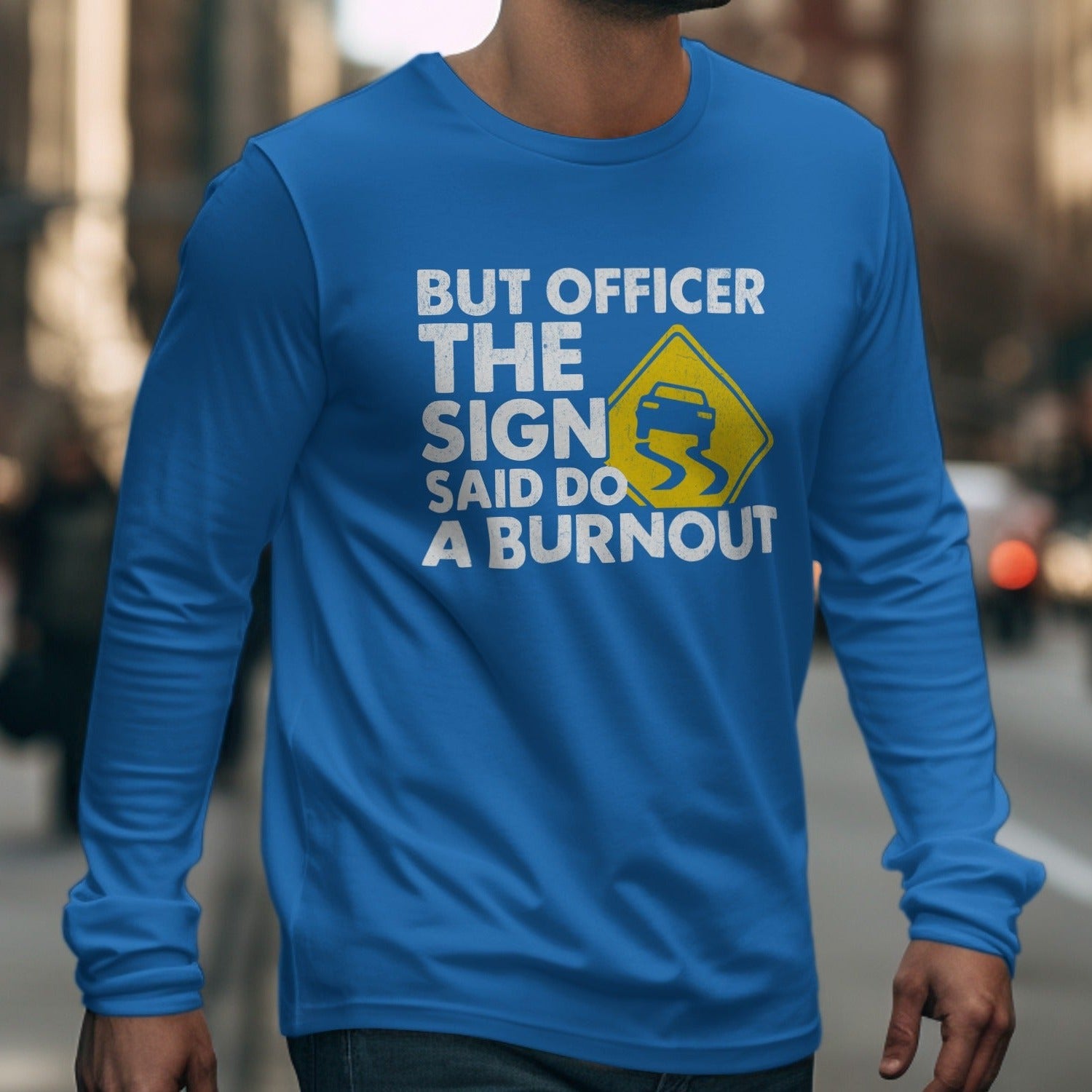 Blue long-sleeve shirt with text "BUT OFFICER THE SIGN SAID DO A BURNOUT".