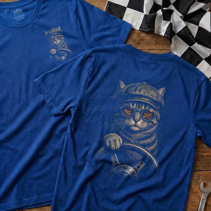 Blue t-shirt with graphic of a cat wearing a flat cap and glasses driving a car.