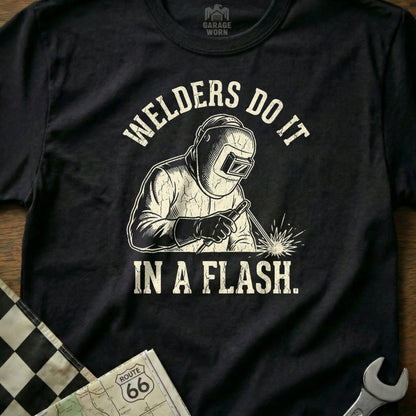 T-shirt graphic of a welder with text "WELDERS DO IT IN A FLASH."