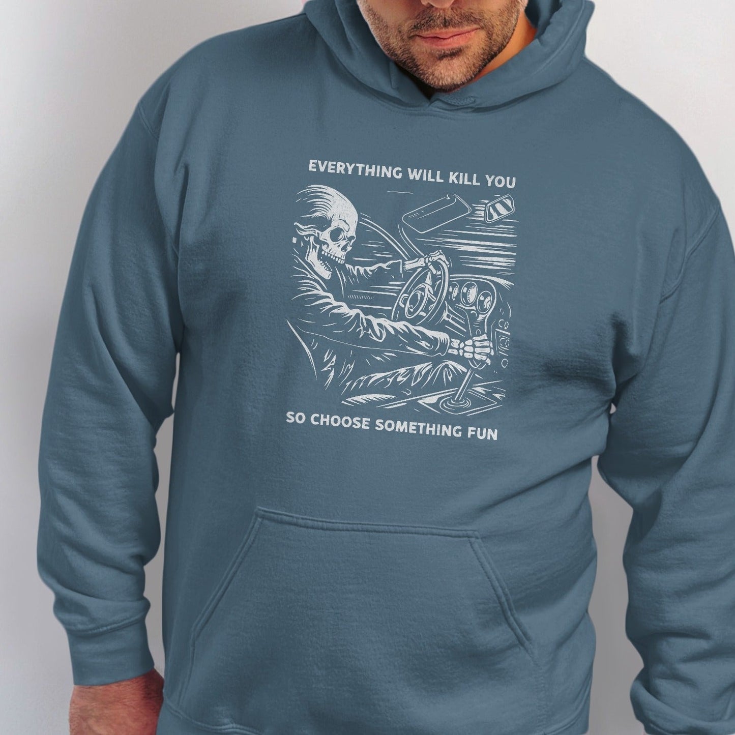 Skeleton driving a car with text "Everything will kill you, so choose something fun".