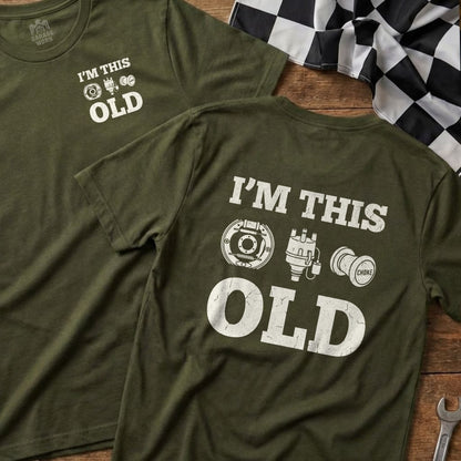 Two olive green t-shirts with "I'M THIS OLD" and car part graphics.