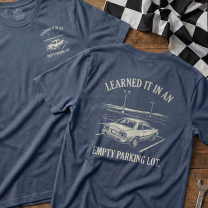 Blue t-shirt with "Learned it in an empty parking lot." text and car illustration.