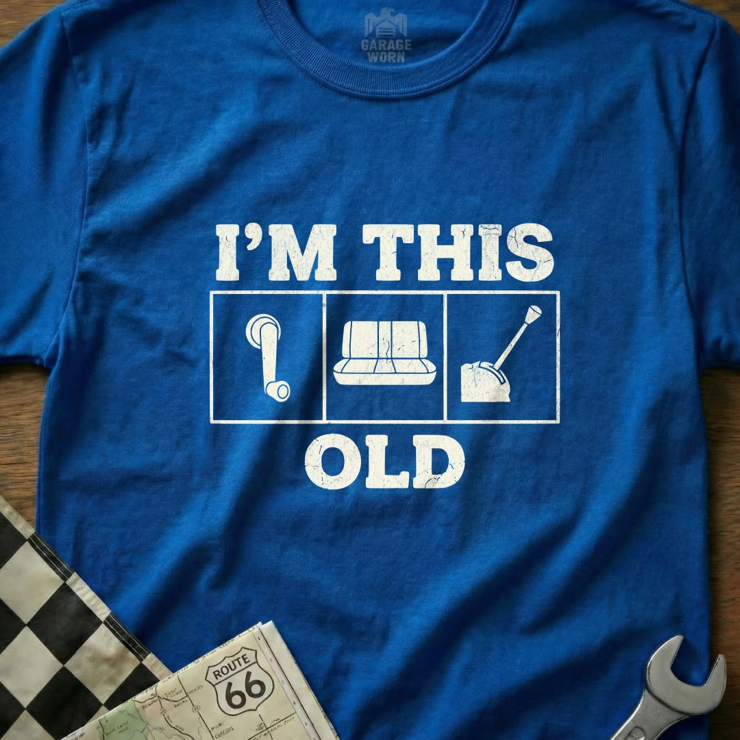 Blue t-shirt with white graphic "I'M THIS OLD" and three icons.