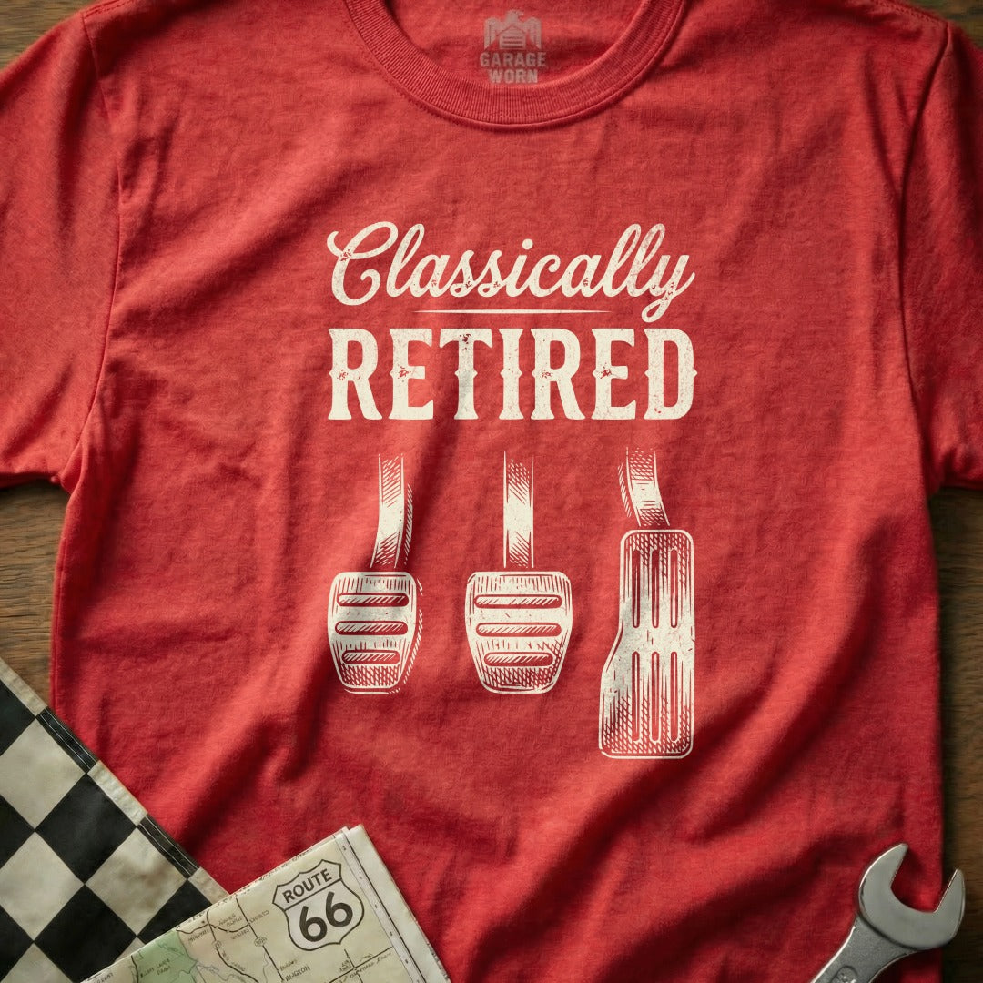 Red t-shirt with "Classically Retired" and car pedals.