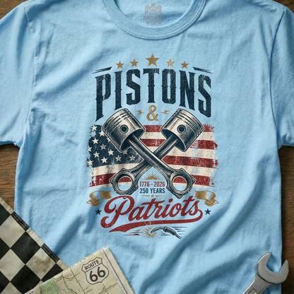Light blue t-shirt with "Pistons & Patriots" and crossed pistons over US flag.