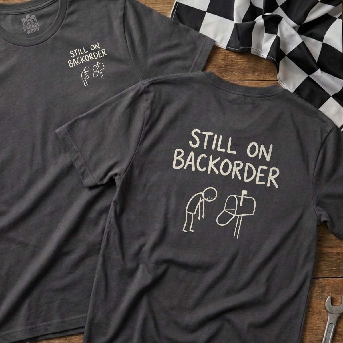 T-shirt with "Still on Backorder" text and a stick figure mailing a letter.