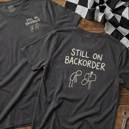 T-shirt with "Still on Backorder" text and a stick figure mailing a letter.
