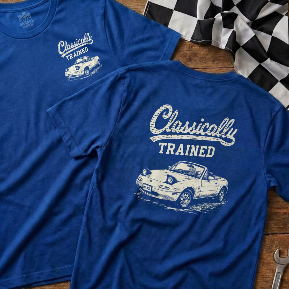 Blue t-shirts printed with "Classically Trained" and a white Mazda Miata convertible.