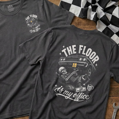 Dark grey t-shirt with skeleton working on car graphic and text "The Floor is my Office."