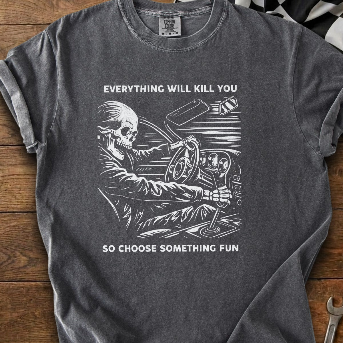 Skeleton driving a car with text "Everything will kill you so choose something fun."