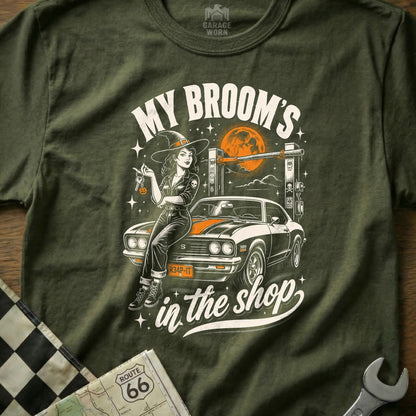 Green t-shirt graphic with witch and car, "My broom's in the shop."