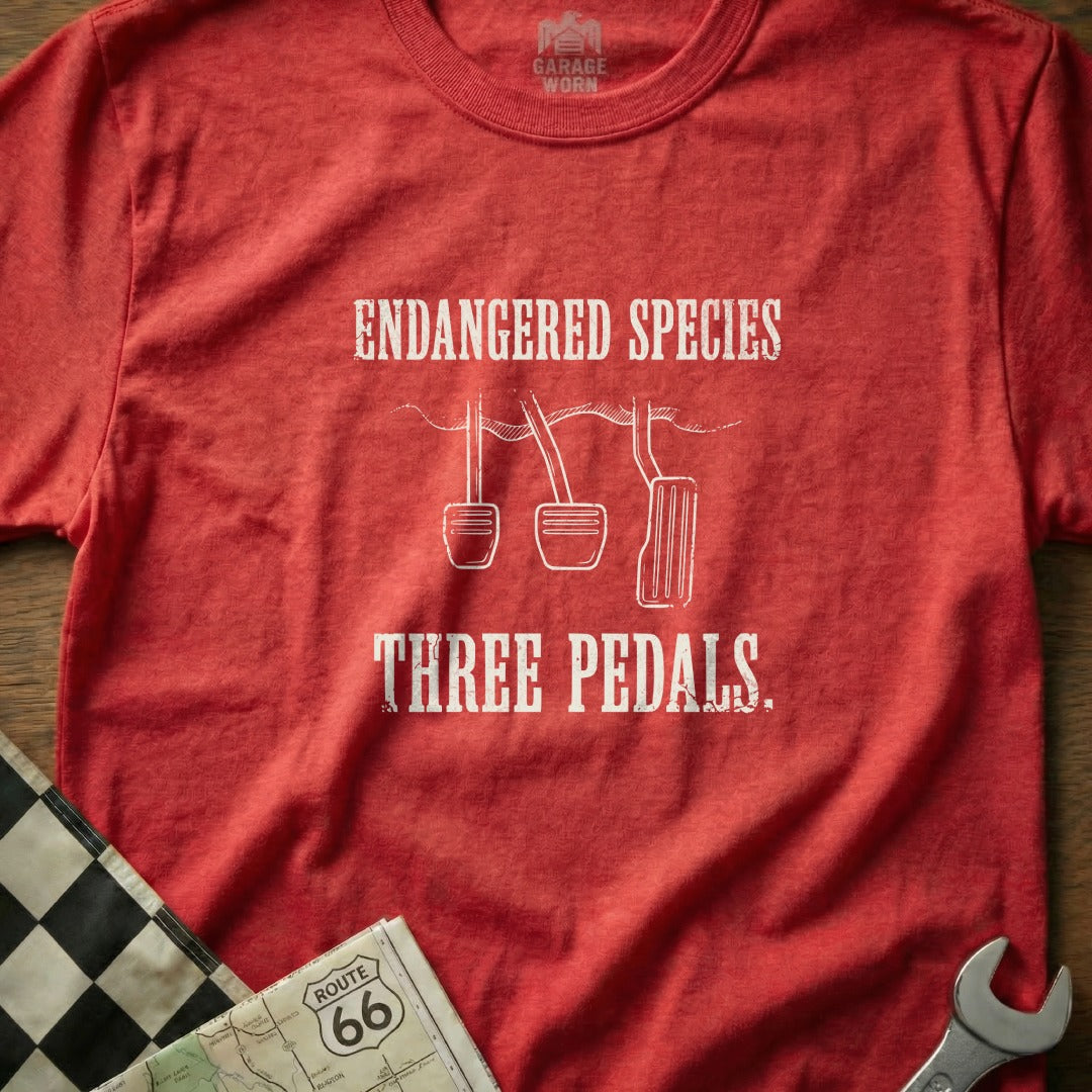 Red t-shirt with "Endangered Species Three Pedals" and pedal graphics.