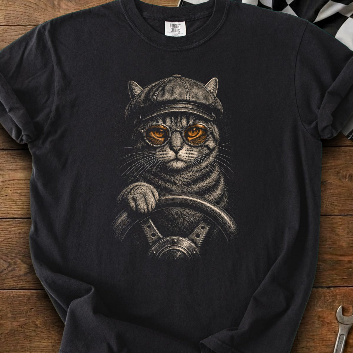 Tabby cat wearing a cap and goggles driving a car.