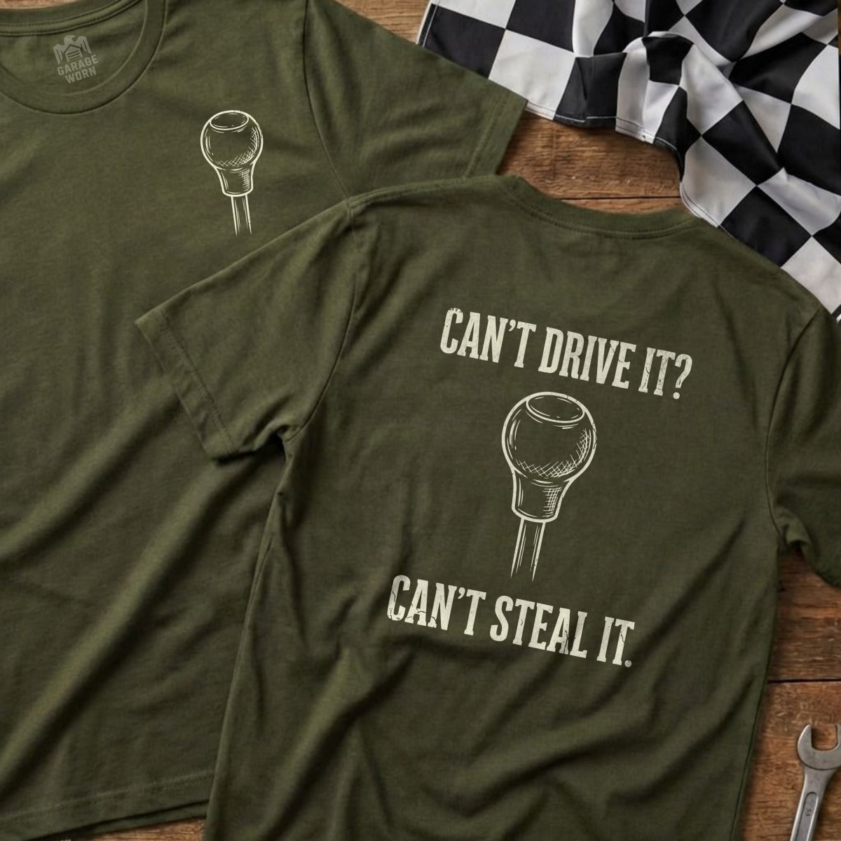 Olive green t-shirt with a shift knob graphic and text "Can't Drive It? Can't Steal It."