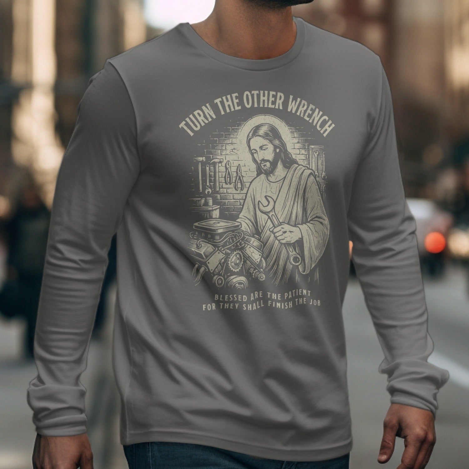Jesus holding a wrench with text "Turn the Other Wrench" and "Blessed are the patient".