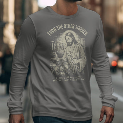 Jesus holding a wrench with text "Turn the Other Wrench" and "Blessed are the patient".