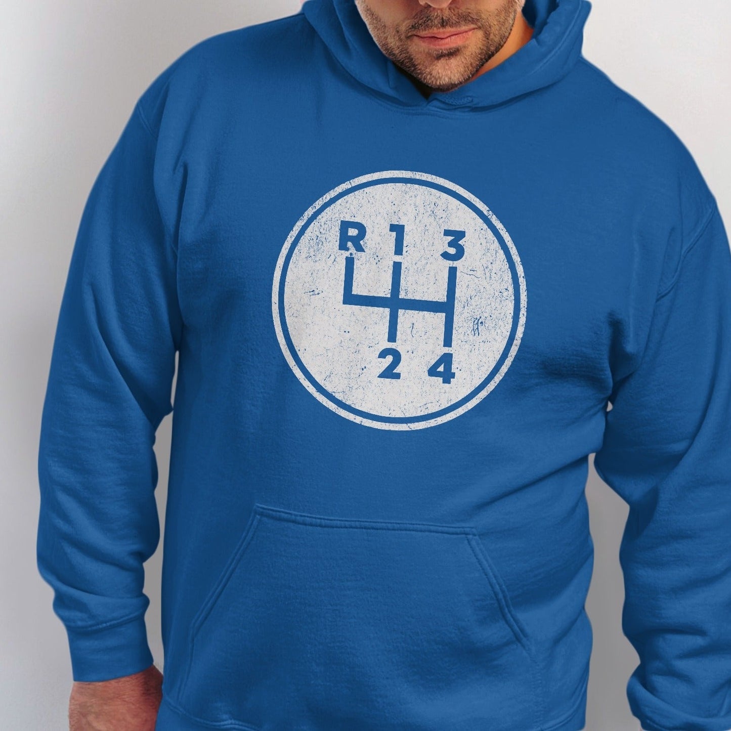 Blue hoodie with a white distressed manual gear shift pattern on the chest.