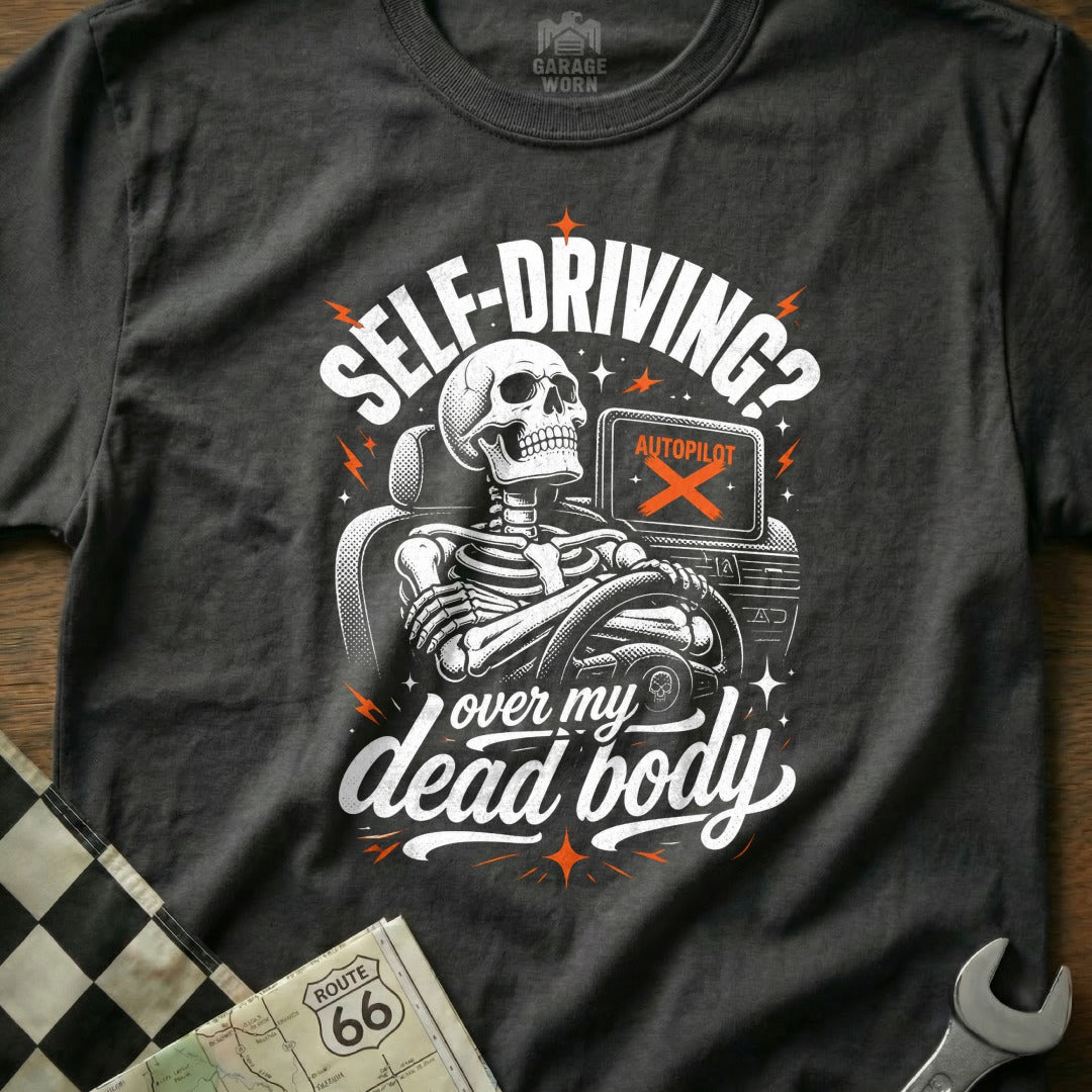 Dark t-shirt with skeleton driving, saying "Self-Driving? Over My Dead Body".