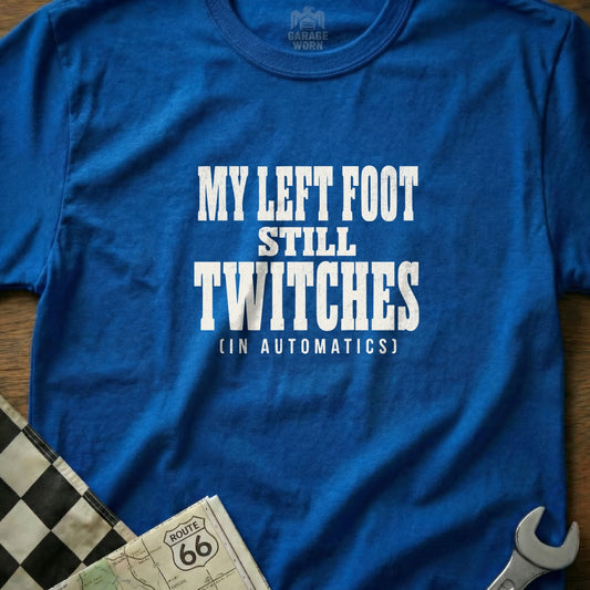 Blue t-shirt with white text "MY LEFT FOOT STILL TWITCHES (IN AUTOMATICS)".